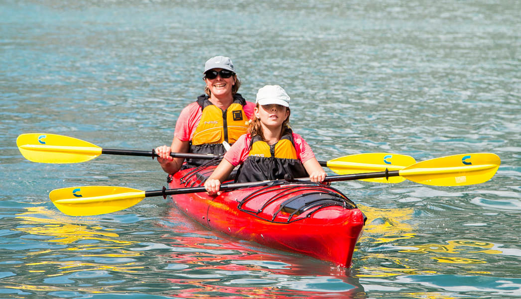 Guests kayaking on the serene waters of the Kali River, Dandeli