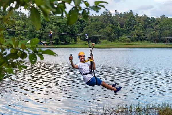 A person ziplining across the river at Dandeli for an adventure experience